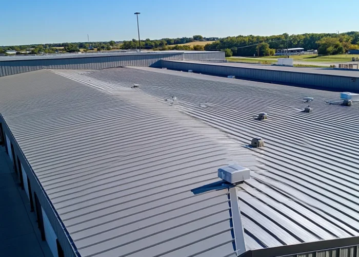 Experts addressing water damage issues on a commercial roof to prevent leaks and structural problems.